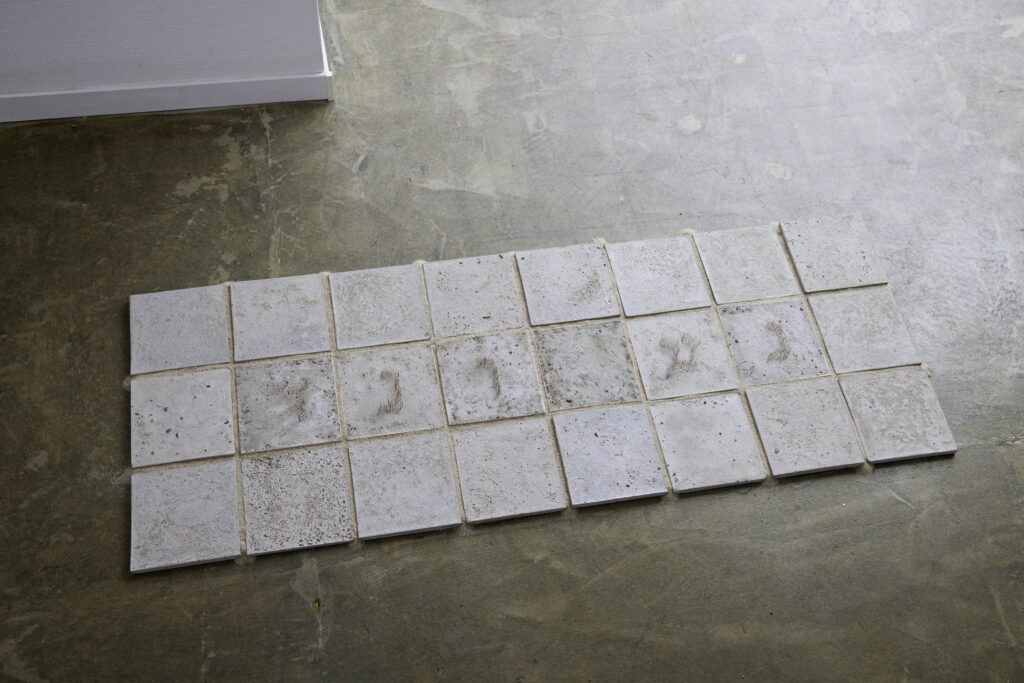 Michal Fuchs, Stable ground #1, 2024, Concrete tiles with Hebrew letters from Cactus drones